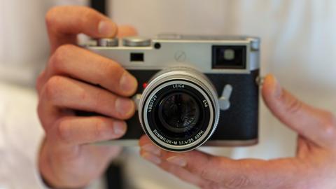 Zwei Hände halten eine Leica-Kamera. Es handelt sich um das Spitzen-Modell, eine Leica M1 1-P.