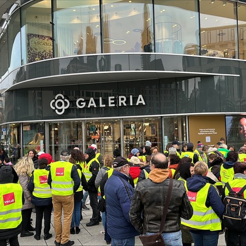 Menschen in Verdi-Westen stehen am Ostersamstag vor der Galeria Filiale in Frankfurt