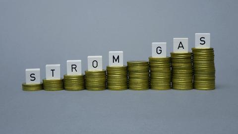 Gestapelte Münzen mit den Buchstaben STROM GAS darüber.