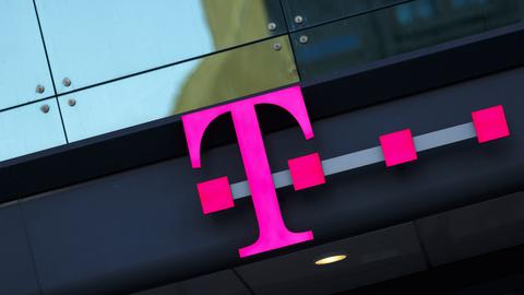 Foto eines Telekom-Logos als Leuchtobjekt an einer Fassade