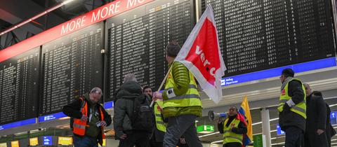 Freitag: Flughafen-Mitarbeiter sind in Streikwesten im Terminal 1 des Frankfurter Flughafens unterwegs. 